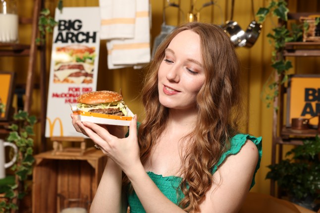 Courtney Pochin holding the new Big Arch burger from McDonald's