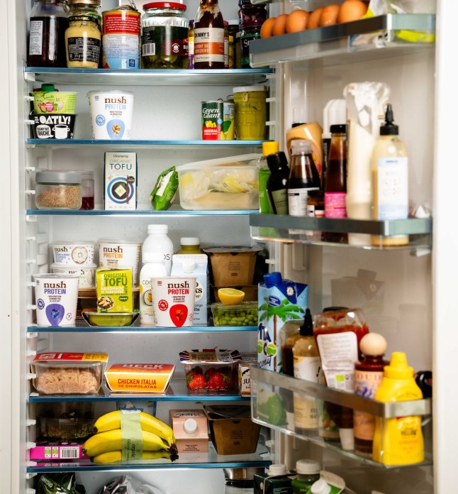 Bethany Eaton with her selection of snacks that she likes to have at home including Manuca honey, Dalesford Chocolate nut butter, frozen avocados, collagen powder, Nush yoghurts, liquid egg whites matcha powder and pineapple and anchovy pizzas. Byline John Nguyen/JNVisuals 19/05/2025