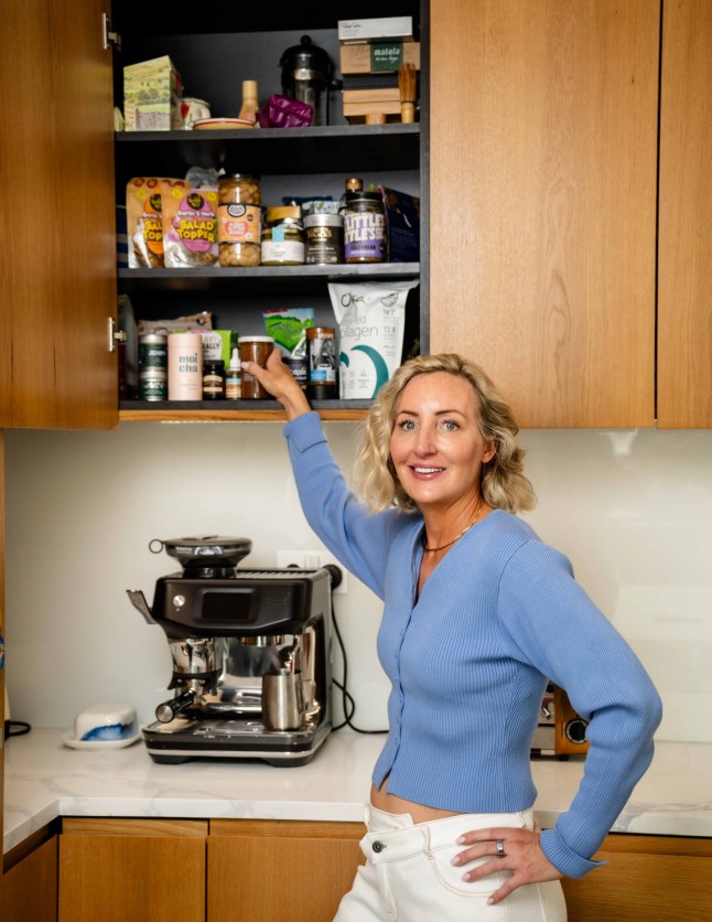 Bethany Eaton with her selection of snacks that she likes to have at home including Manuca honey, Dalesford Chocolate nut butter, frozen avocados, collagen powder, Nush yoghurts, liquid egg whites matcha powder and pineapple and anchovy pizzas. Byline John Nguyen/JNVisuals 19/05/2025
