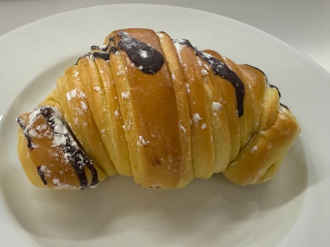 The chocolate brioche croissant from Lidl on a plate