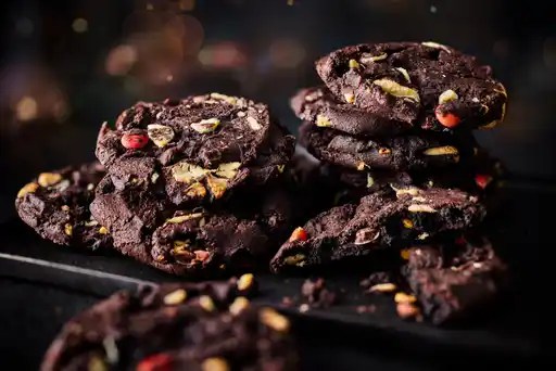 M&S new peppermint bark cookies on a tray with a dark background